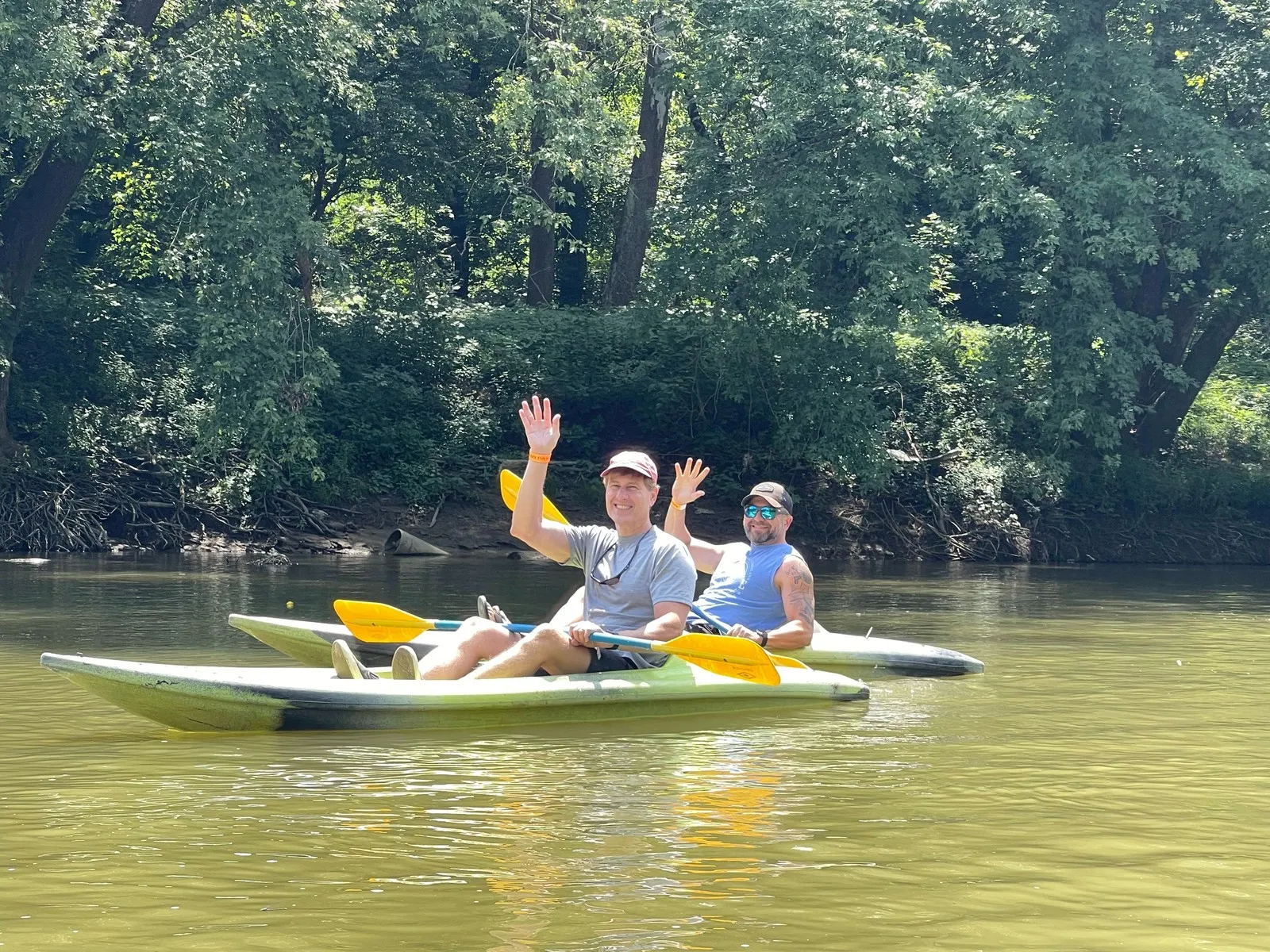 Two team members kayaking on the river at a company event